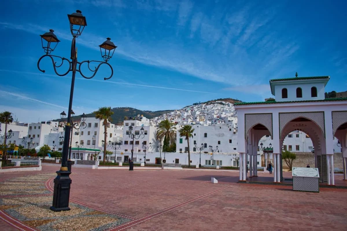 Hassan II Square in Tetouan with street lamps and white houses behind