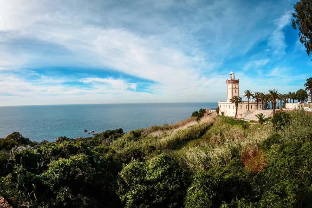 Cape Spartel lighthouse above the Atlantic coast and green hillside